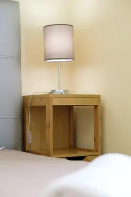 a lamp sitting on a table next to a bed at GuestReady - An amazing blue ocean view in Funchal