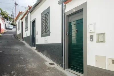 a green door on a building on a street at GuestReady - An amazing blue ocean view in Funchal