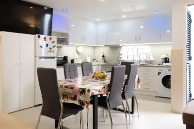 a kitchen with a table with chairs and a refrigerator at GuestReady - An amazing blue ocean view in Funchal