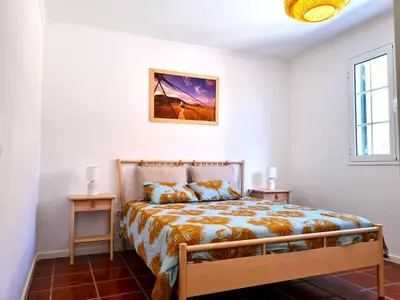 a bedroom with a bed and two night stands at Abrigo das Matas in Porto Santo
