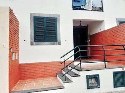 a building with a staircase and a window at Abrigo das Matas in Porto Santo