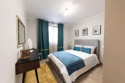 a bedroom with a bed and a table and a mirror at SWEET home I in Caniçal