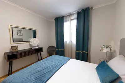 a bedroom with a bed and a mirror and a window at SWEET home I in Caniçal