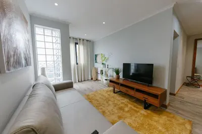 a living room with a couch and a flat screen tv at SWEET home I in Caniçal
