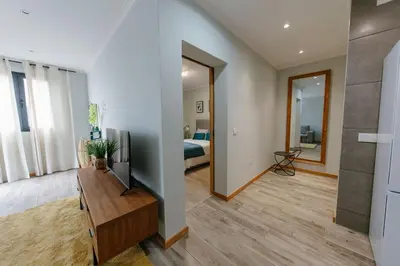 a living room with a television and a bedroom at SWEET home I in Caniçal