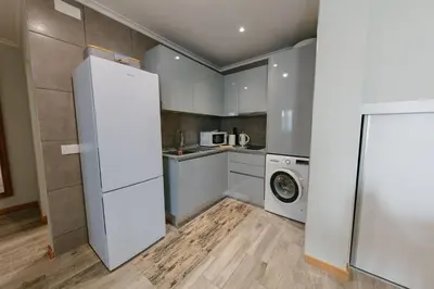 a kitchen with a refrigerator and a washing machine at SWEET home I in Caniçal