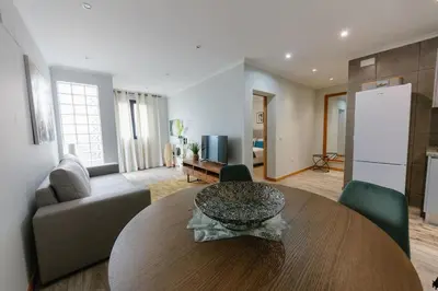 a living room with a table and a couch and a kitchen at SWEET home I in Caniçal