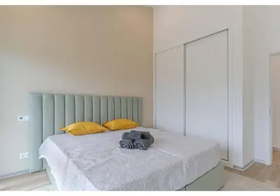a bedroom with a blue bed with a large window at The pool house in Ponta de Sol in Funchal