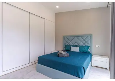 a bedroom with a large bed with a window at The pool house in Ponta de Sol in Funchal