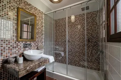 a bathroom with a sink and a glass shower at Casa do Rosário by An Island Apart in São Vicente