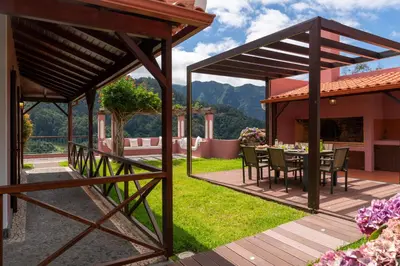a wooden deck with a table and chairs on a house at Casa do Rosário by An Island Apart in São Vicente