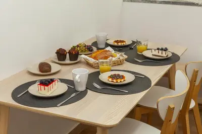 a wooden table with plates of food on it at B69 - Village of Luz Apartment in Luz
