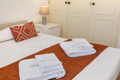 a bedroom with a bed with white towels on it at B69 - Village of Luz Apartment in Luz