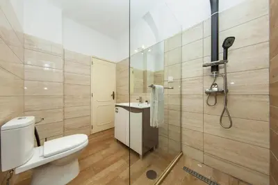 a bathroom with a shower and a toilet and a sink at B69 - Village of Luz Apartment in Luz