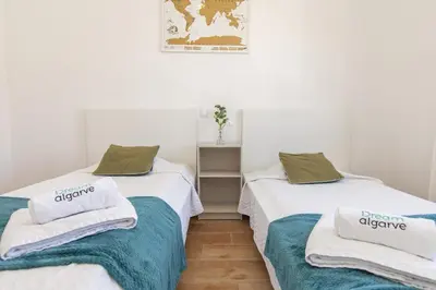 a room with two beds with towels on them at B69 - Village of Luz Apartment in Luz