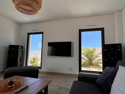 a living room with two windows and a tv at Villa Sonata in Ingrina Sol in Raposeira