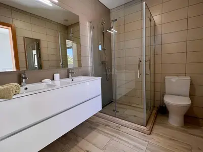 a bathroom with a shower and a sink and a toilet at Villa Sonata in Ingrina Sol in Raposeira