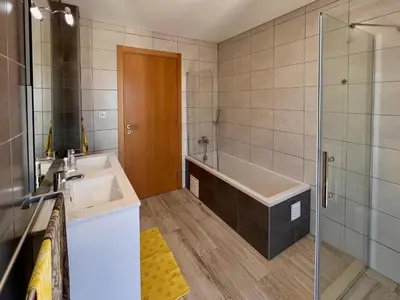 a bathroom with a tub and a sink and a shower at Villa Sonata in Ingrina Sol in Raposeira