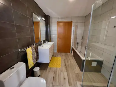 a bathroom with a toilet and a sink and a tub at Villa Sonata in Ingrina Sol in Raposeira