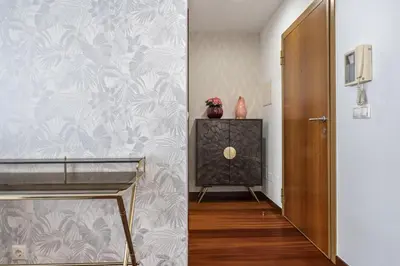 a hallway with a door and a wall with floral wallpaper at Fifth Apartment by Homie in Funchal