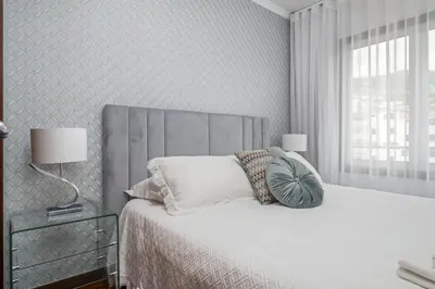 a bedroom with a bed with a gray headboard at Fifth Apartment by Homie in Funchal