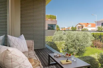 a balcony with a couch and a table with a view at Savoy Residence Casa Branca II by An Island Apart in Funchal