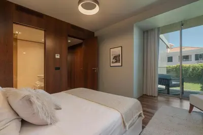 a bedroom with a bed and a sliding glass door at Savoy Residence Casa Branca II by An Island Apart in Funchal