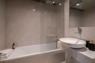 a bathroom with a sink and a tub and a toilet at Savoy Residence Casa Branca II by An Island Apart in Funchal