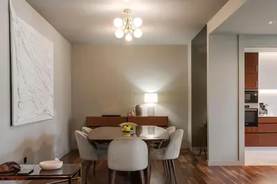a dining room and kitchen with a table and chairs at Savoy Residence Casa Branca II by An Island Apart in Funchal