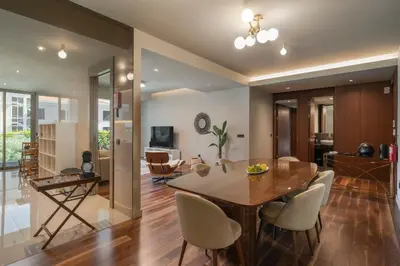 a dining room and living room with a table and chairs at Savoy Residence Casa Branca II by An Island Apart in Funchal