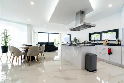 a kitchen and dining room with a table and chairs at Villa Rocha in Arco da Calheta in Arco da Calheta
