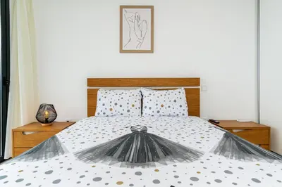 a bedroom with a large bed with polka dot sheets at Villa Rocha in Arco da Calheta in Arco da Calheta