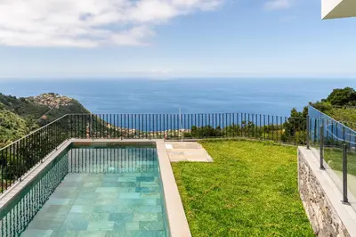 a swimming pool with a view of the ocean at Villa Rocha in Arco da Calheta in Arco da Calheta
