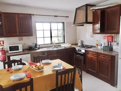 a kitchen with a table with a bowl of fruit on it at Casa Manuel J. J. M -Alfambras, Aljezur - Quiet Country House in Aljezur