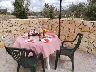 a table with a pink tablecloth and two chairs at Casa Manuel J. J. M -Alfambras, Aljezur - Quiet Country House in Aljezur
