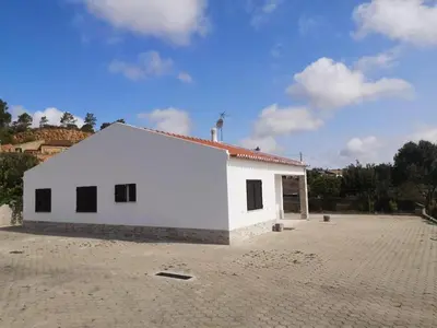 a large white building with a brick lot at Casa Manuel J. J. M -Alfambras, Aljezur - Quiet Country House in Aljezur