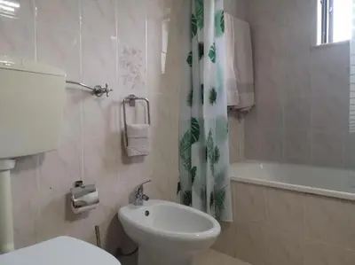 a bathroom with a toilet and a sink and a bath tub at Casa Manuel J. J. M -Alfambras, Aljezur - Quiet Country House in Aljezur