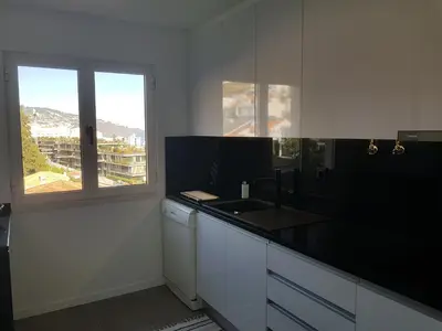 a white kitchen with a sink and a window at The Sunrise of your Dreams with Total Ocean View with New Modern Kitchens 75 m2 in Funchal