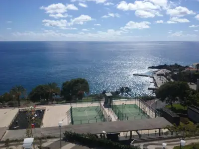 a view of a tennis court and the ocean at The Sunrise of your Dreams with Total Ocean View with New Modern Kitchens 75 m2 in Funchal