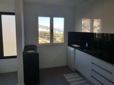 a kitchen with a counter and a sink and a window at The Sunrise of your Dreams with Total Ocean View with New Modern Kitchens 75 m2 in Funchal