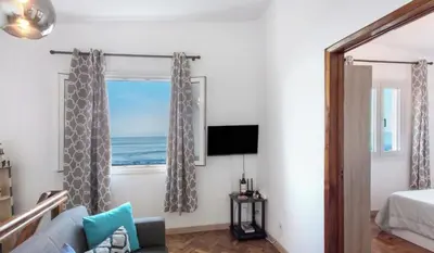 a room with a window with a view of the ocean at Casa dos avós in São Vicente