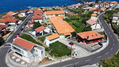 an aerial view of a small town with houses at Sea & Mountain by Atlantic Holiday in Ilhéu Mole