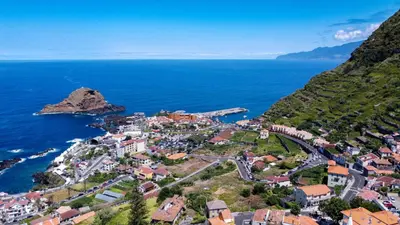 an aerial view of a town on a hill next to the ocean at Sea & Mountain by Atlantic Holiday in Ilhéu Mole
