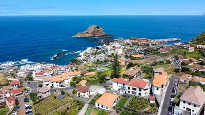 an aerial view of a town next to the ocean at Sea & Mountain by Atlantic Holiday in Ilhéu Mole