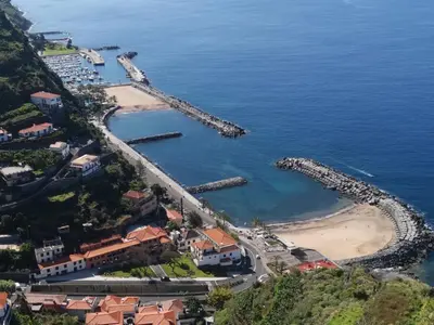 an aerial view of a beach and a harbor at Chalé Esmeralda - Charming Studios in Calheta Beach in Calheta