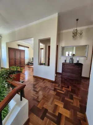 a living room with wooden flooring and a large room at Villa Vista Norte in Porto Moniz