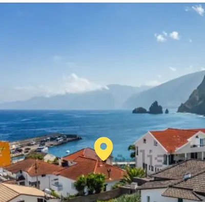a view of a town with a yellow dot at Villa Vista Norte in Porto Moniz