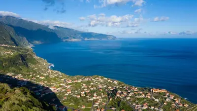 an aerial view of a town on a hill next to the ocean at Faria's House in Ponta Delgada