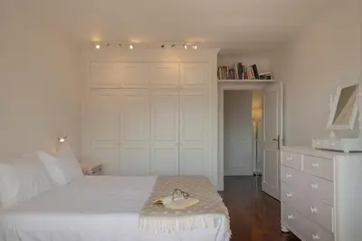 a bedroom with a white bed with a hat on it at Vista Mar I by An Island Apart in Funchal