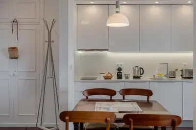 a kitchen with a wooden table and two chairs at Vista Mar I by An Island Apart in Funchal